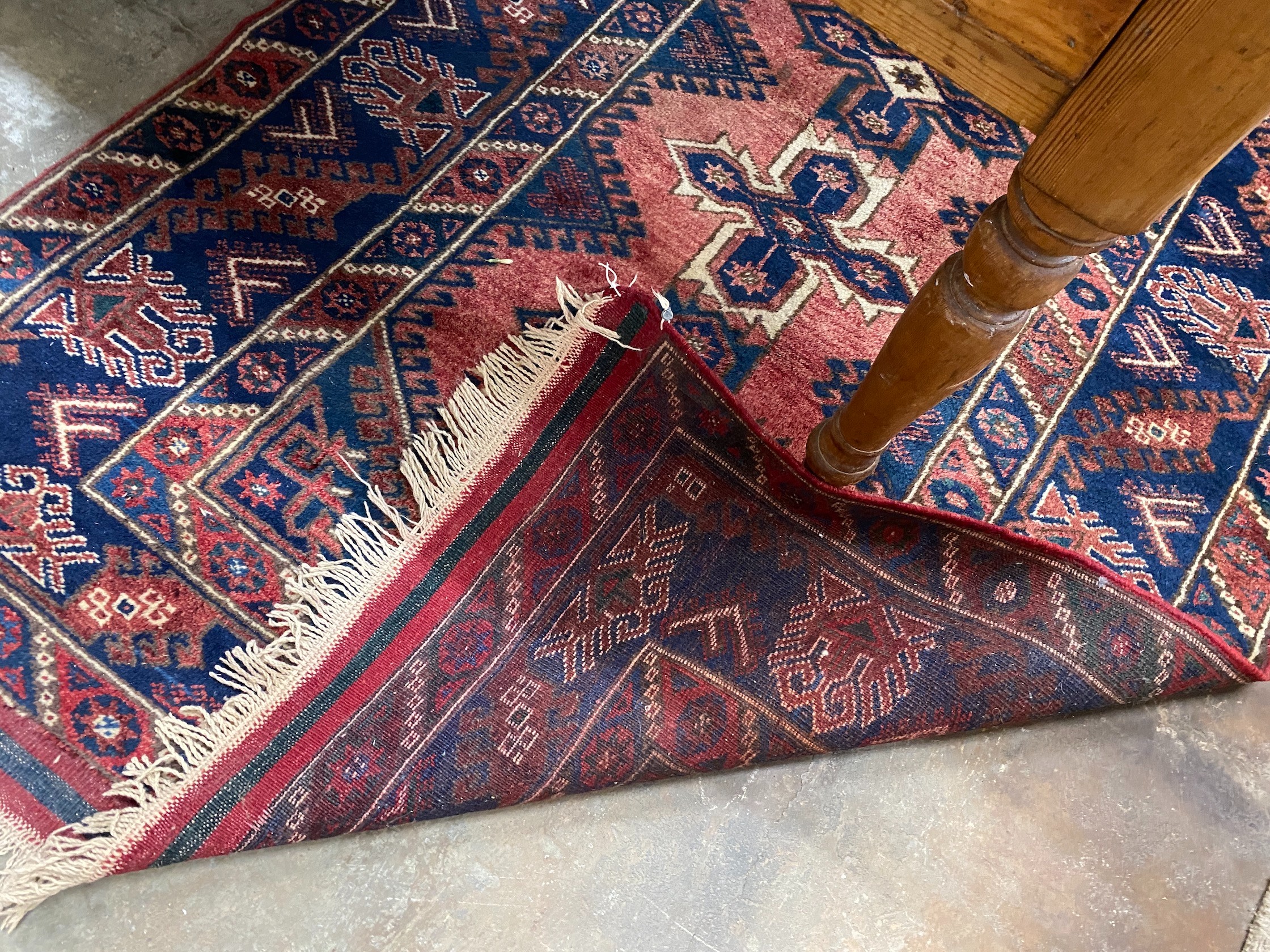 A Caucasian style red ground rug, 184 x 130cm